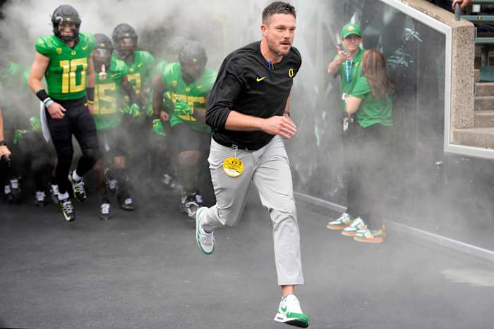 Oregon Ducks head coach Dan Lanning leads his team on the field prior to a game.